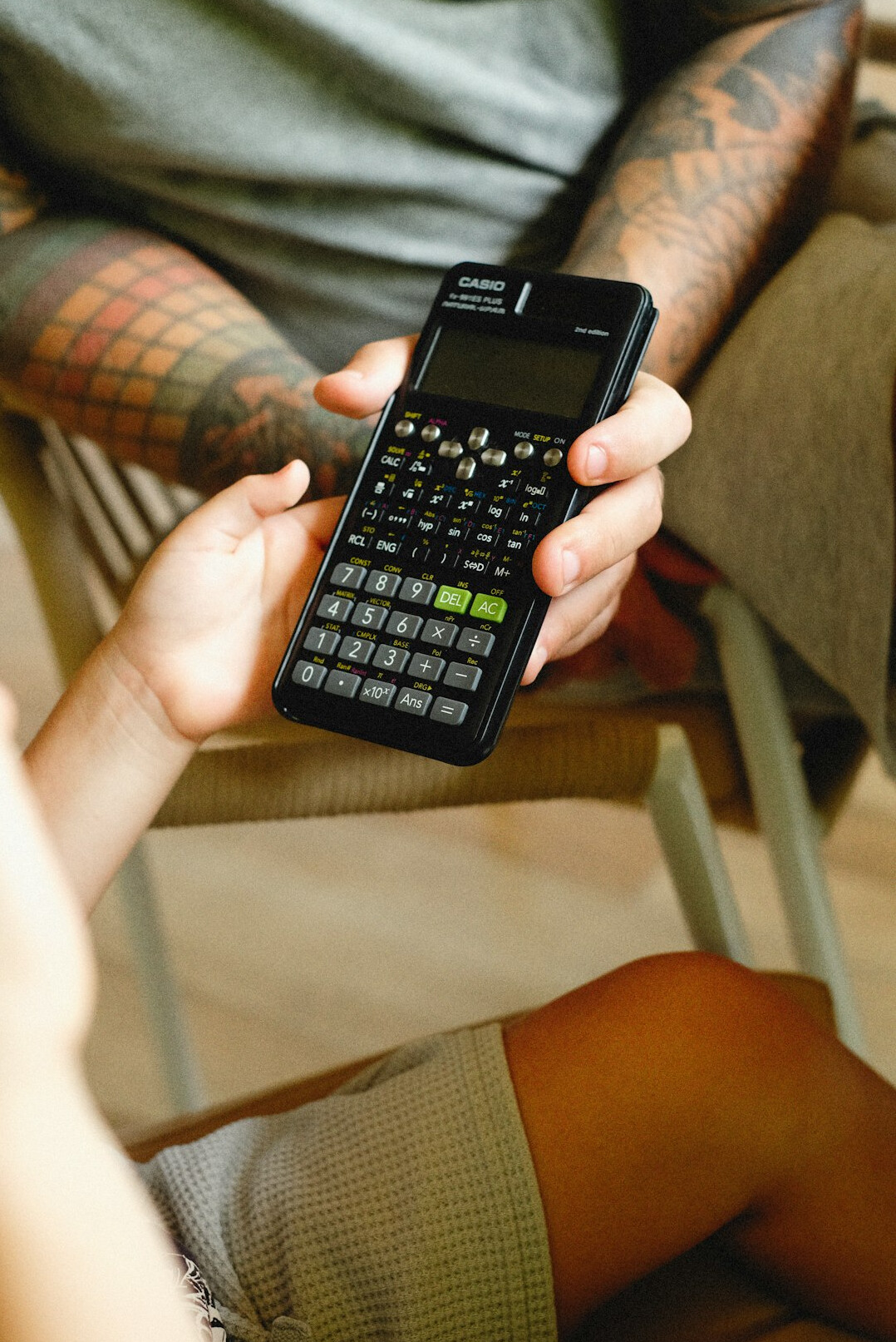 person calculating debts on calculator